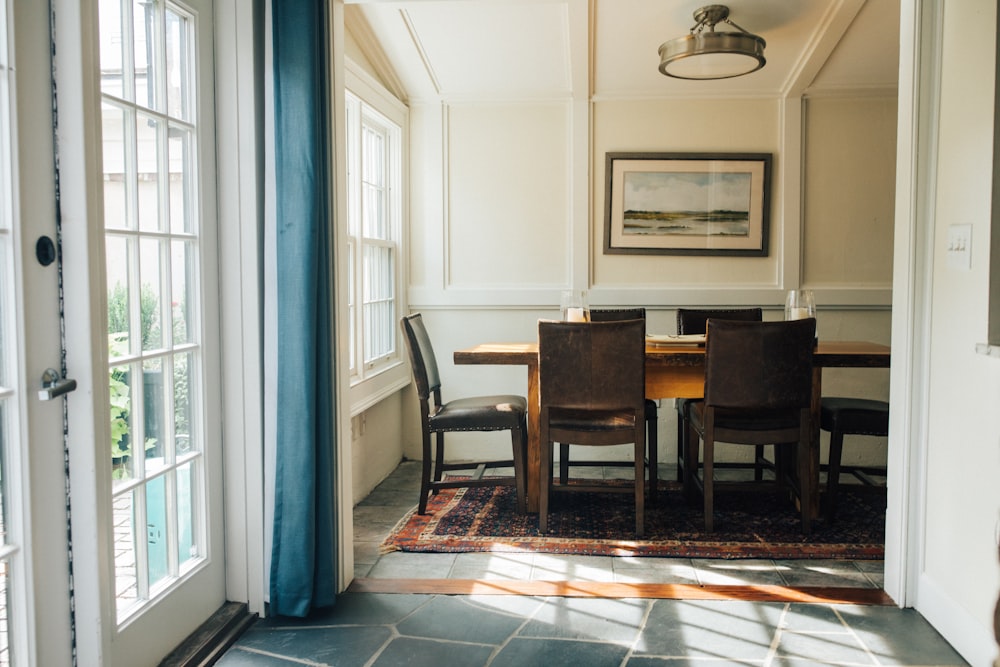 rectangular brown wooden dining table near door