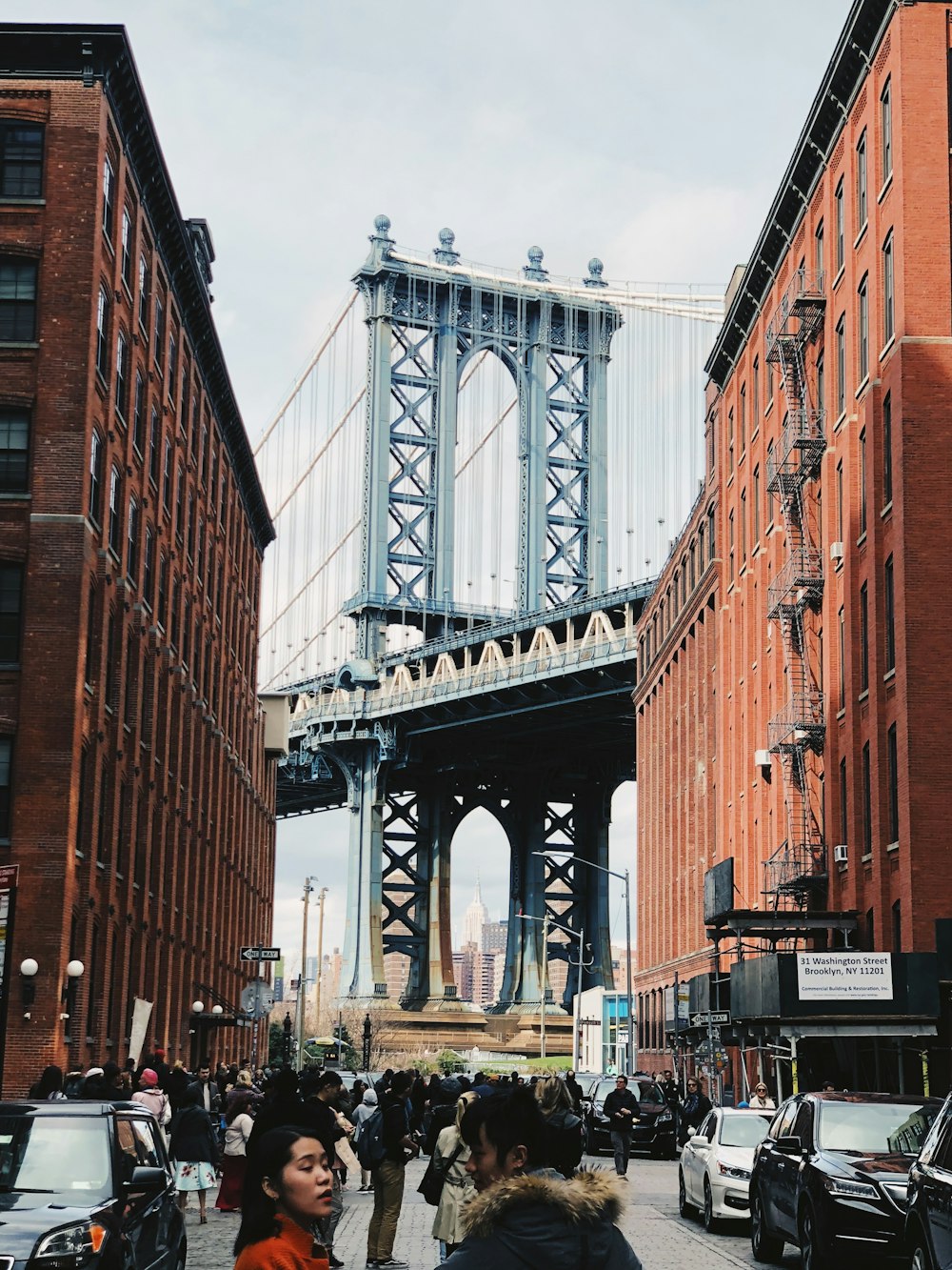 people standing near suspension bridge