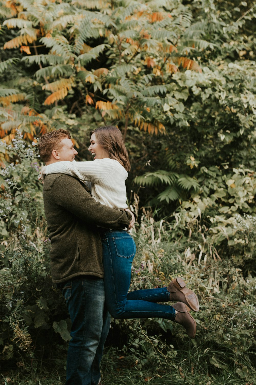 couple beside green leafed tree during daytime