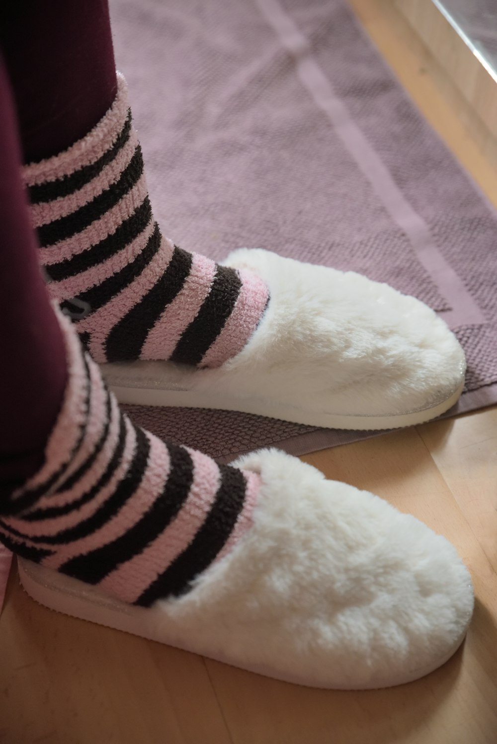 person wearing white bedroom slippers