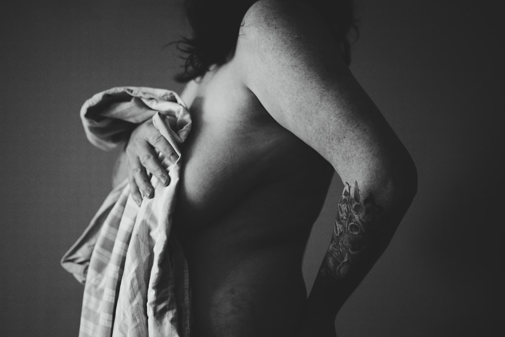 grayscale photography of woman holding cloth
