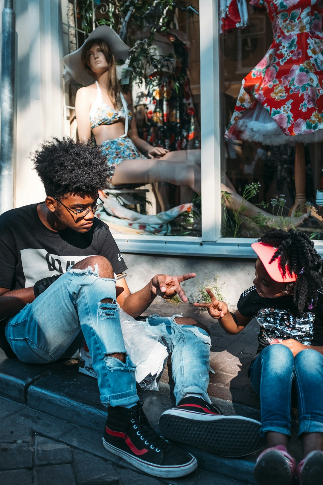 people sitting near mannequin during daytime