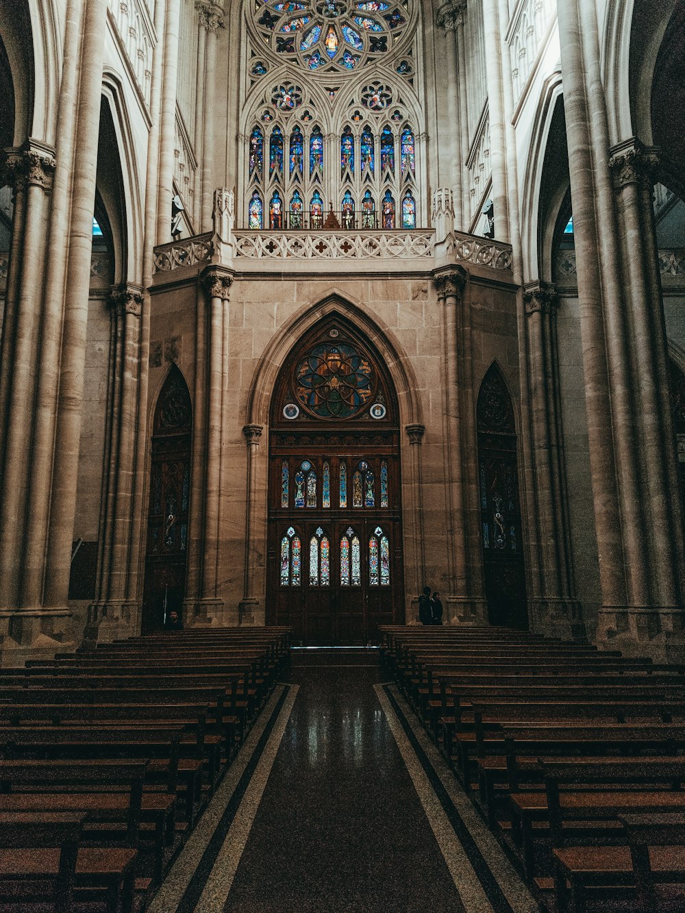 pile of brown benches inside cathedral