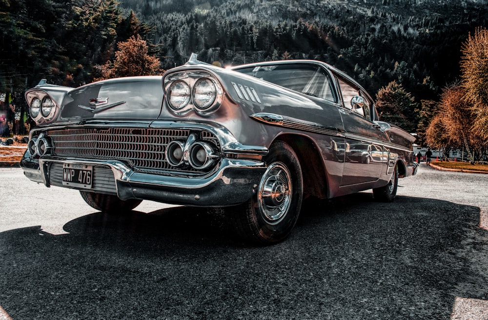 grey classic car on paved road during daytime