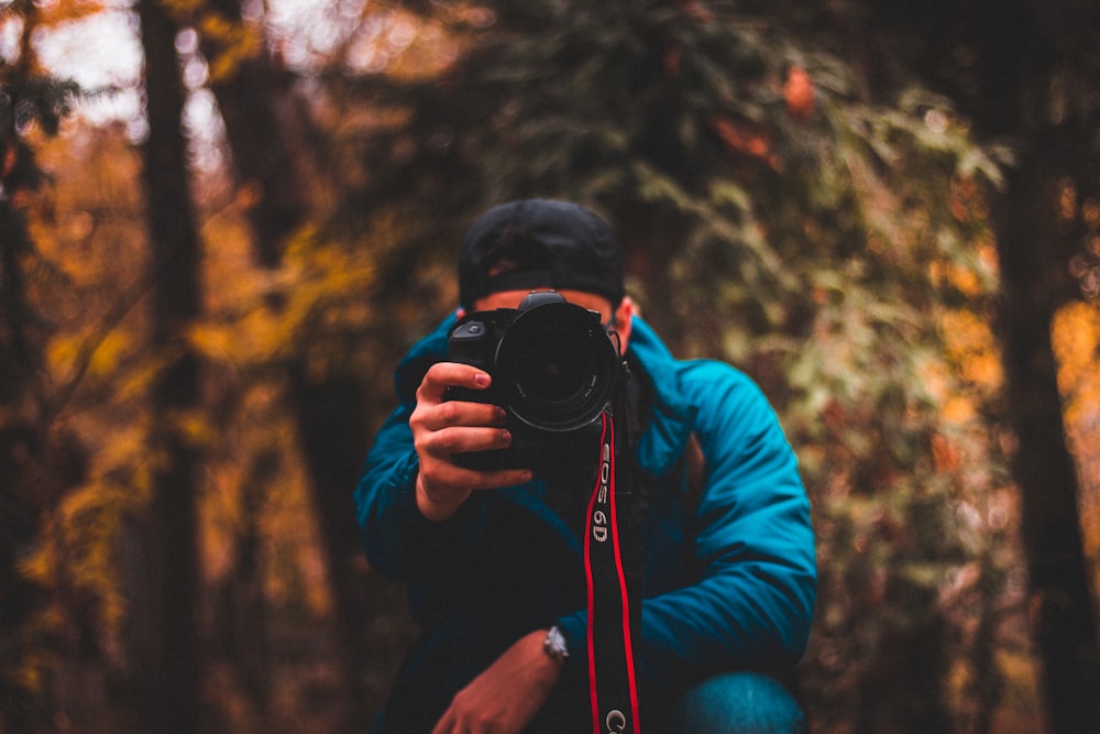 man holding camera taking picture