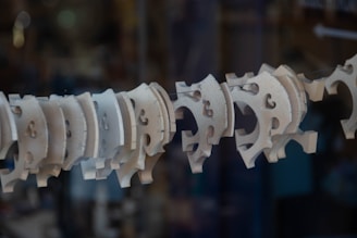 An array of intricately cut wooden and acrylic designs displayed on a workbench.