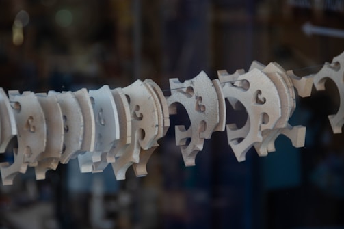 An array of intricately cut wooden shapes on a table.