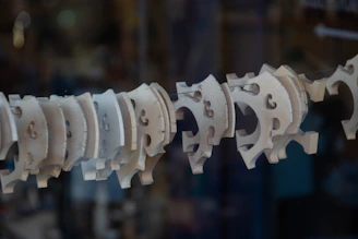 Close-up of detailed 3D printed and laser-cut pieces arranged artistically on a wooden table