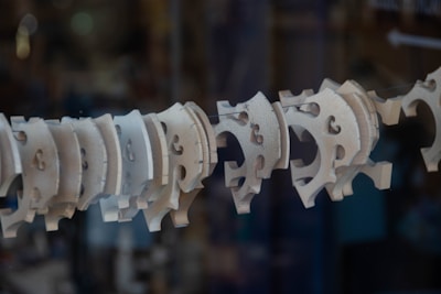 A close-up of intricate laser-cut MDF shapes arranged artistically on a wooden table.