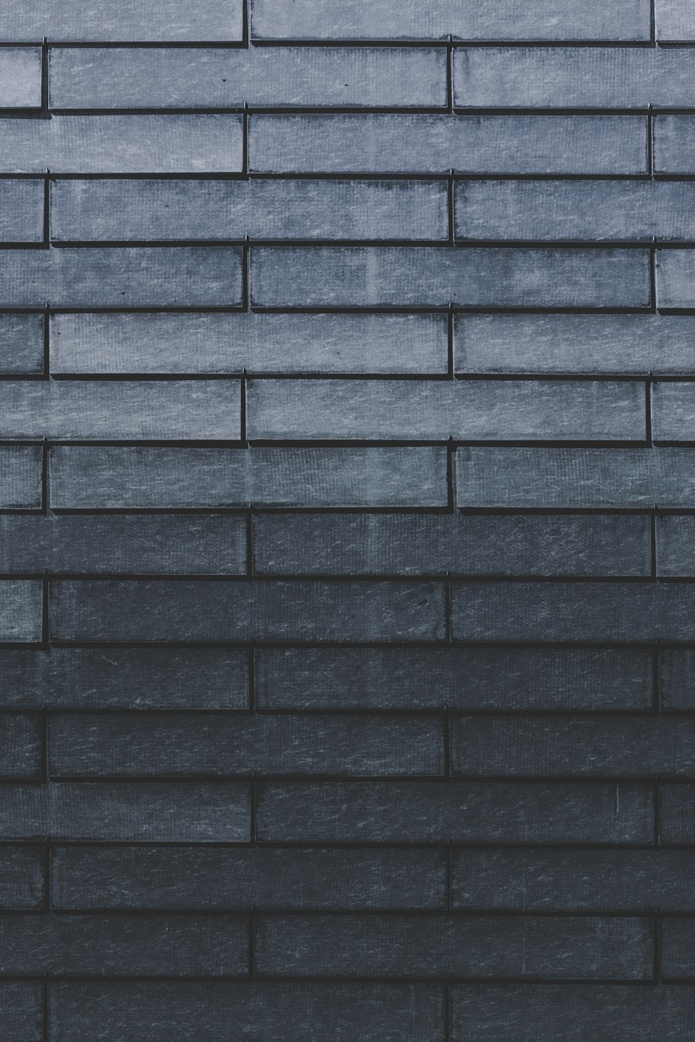 Primer plano de la pared de ladrillo gris
