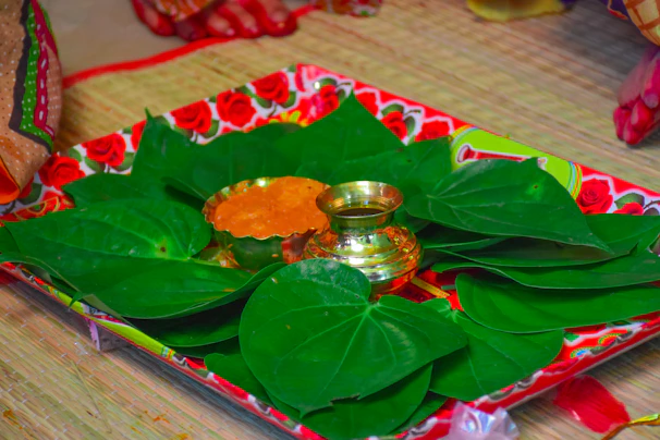 An elegant set of tulsi malas neatly arranged on a wooden tray with fresh tulsi leaves.