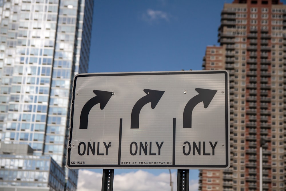 rectangular white and black right turn only street sign