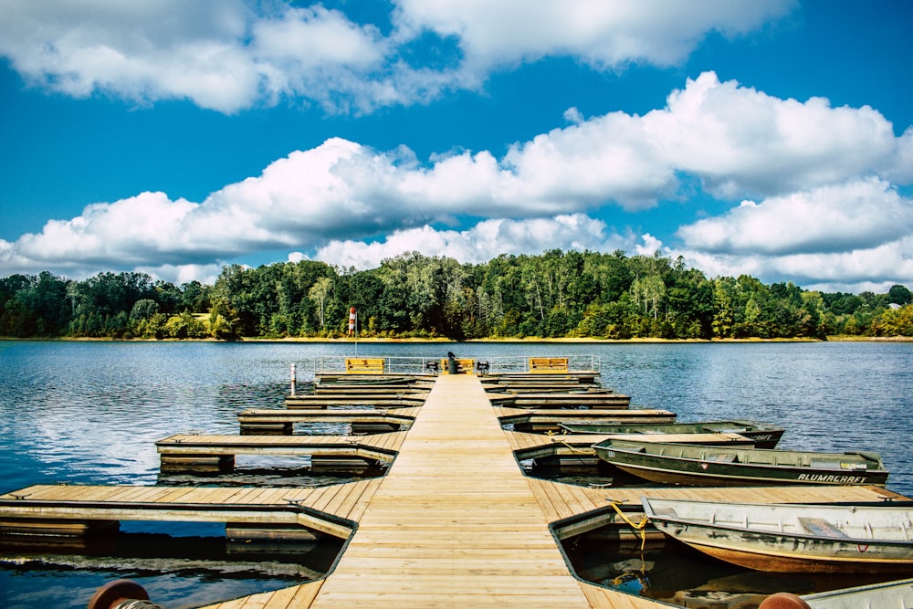 a wooden dock with several boats docked on it