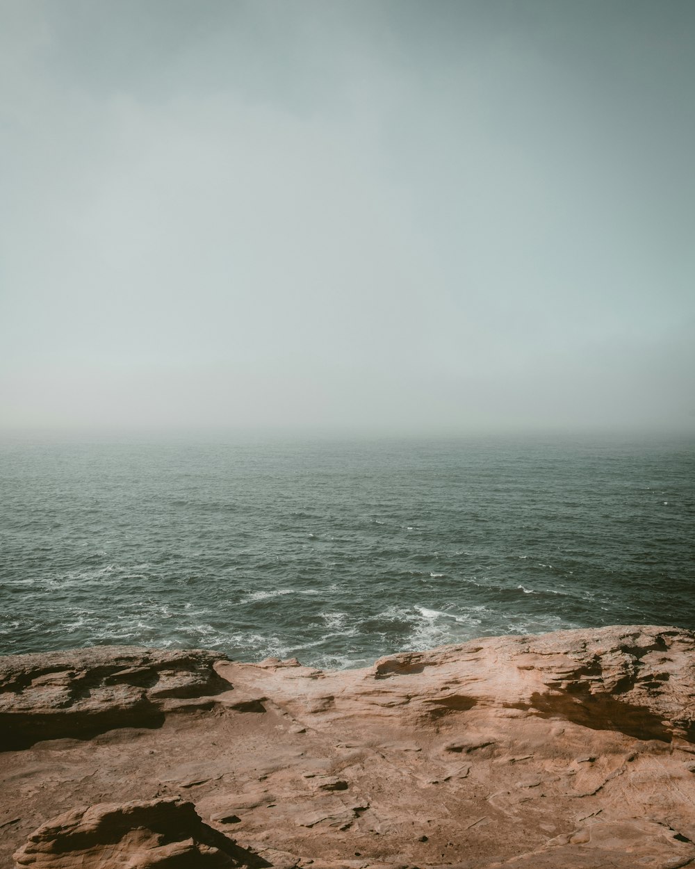 rocky cliff in facing ocean