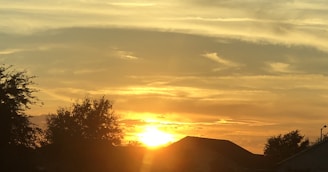 A vibrant sunset over Ville Soulei, casting warm golden light on the landscape.