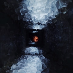 A player exploring a mysterious underground cave lit by crystals.