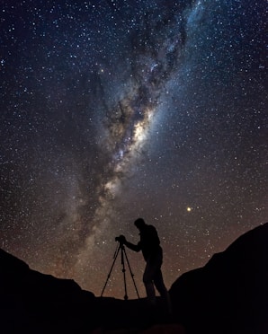 silhouette photo of man under Aurora phenomenon