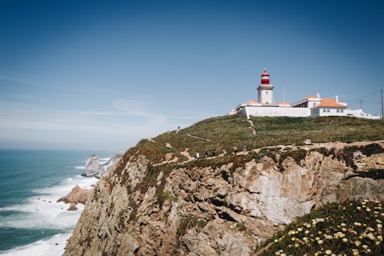 white and red lighthouse in the top of mountain in Sintra-Cascais Natural Park Portugal