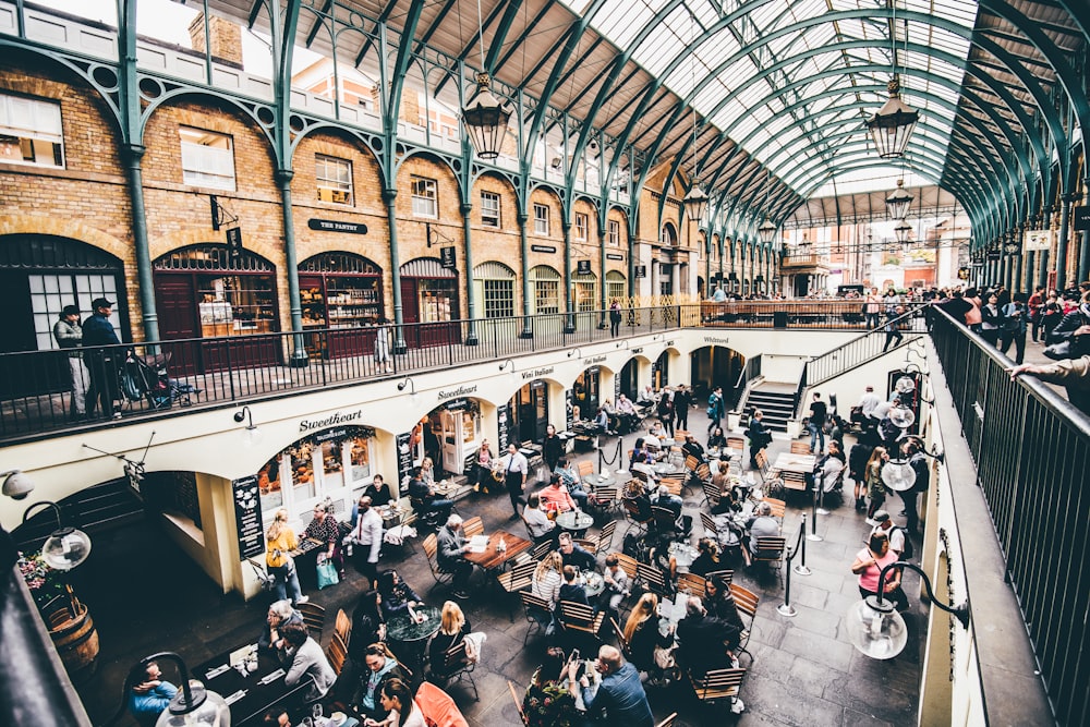 crowded people sitting on chair inside building