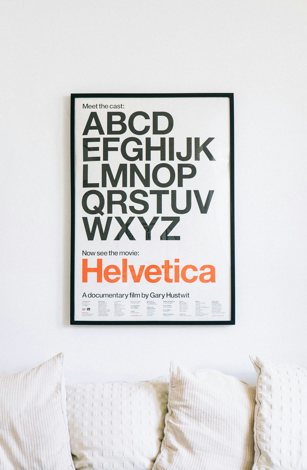  wall mounted helvetica alphabet poster above sofa poster