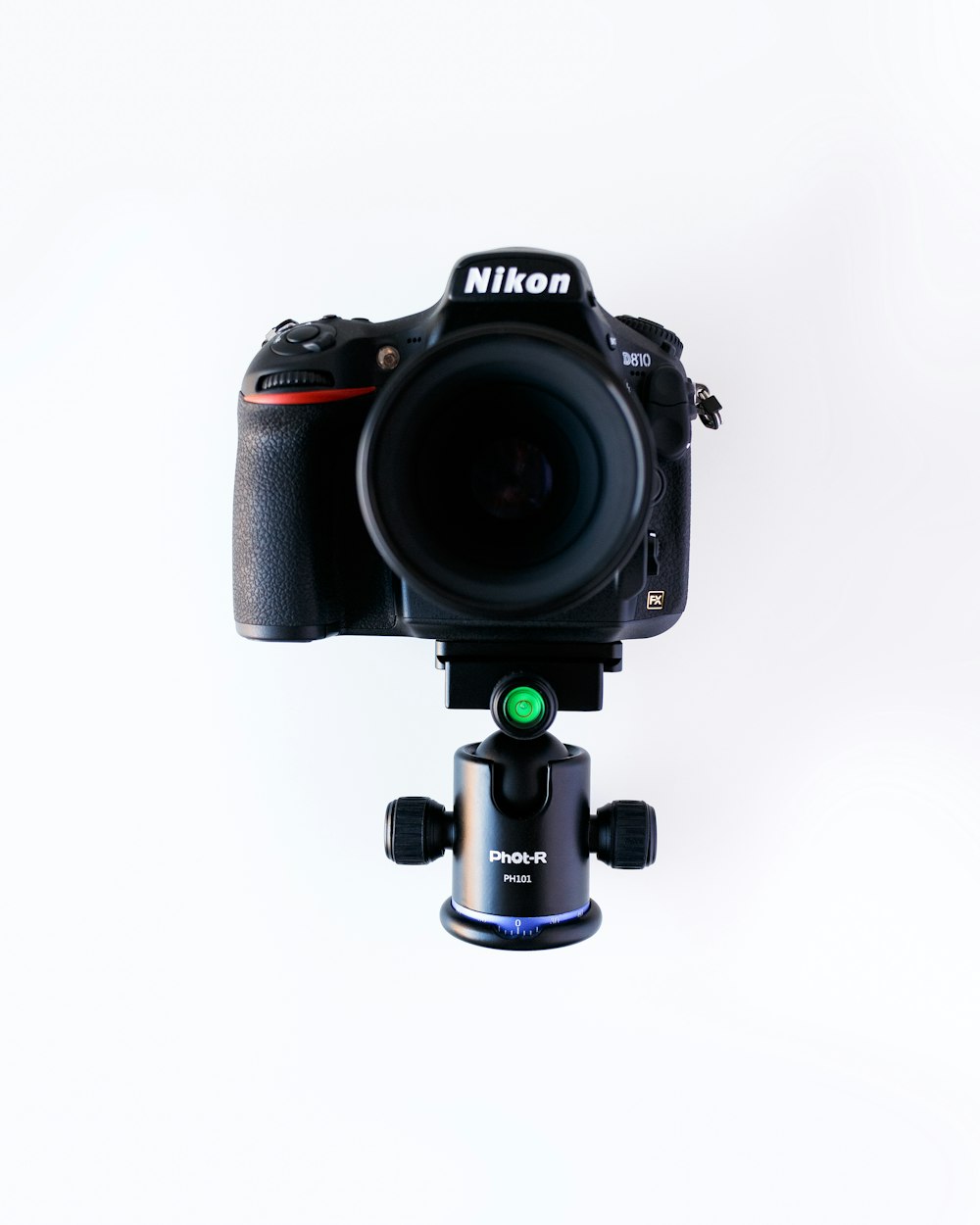 black Nikon DSLR camera with lens