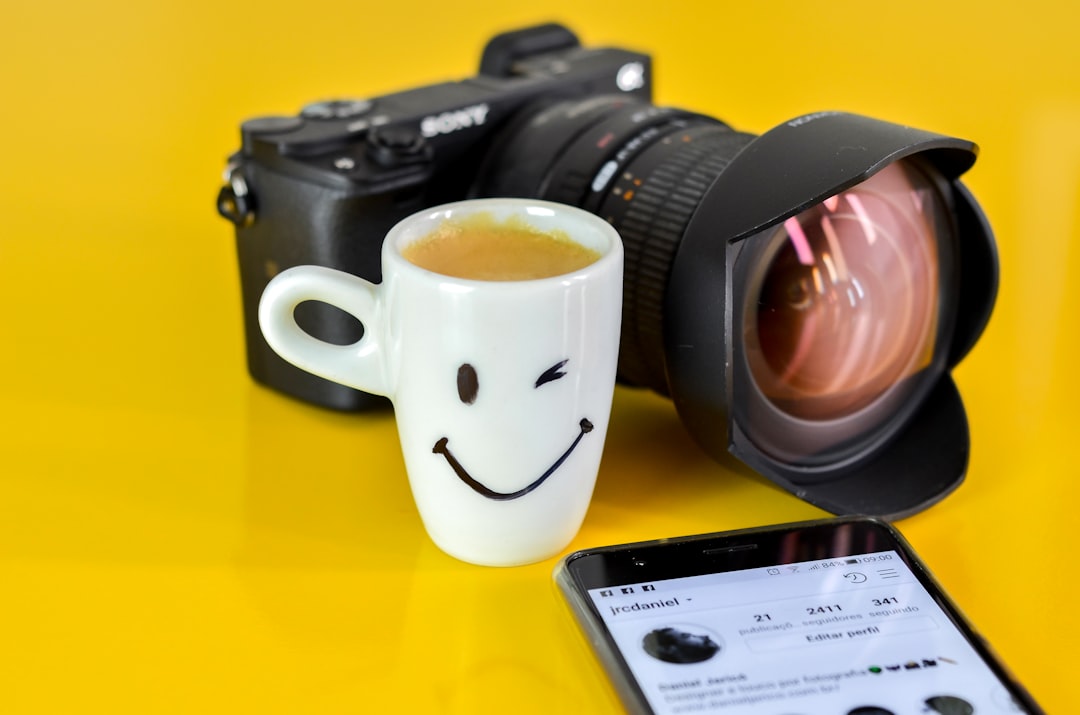 white ceramic smiley mug near camera,