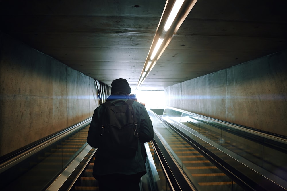 man riding escalator