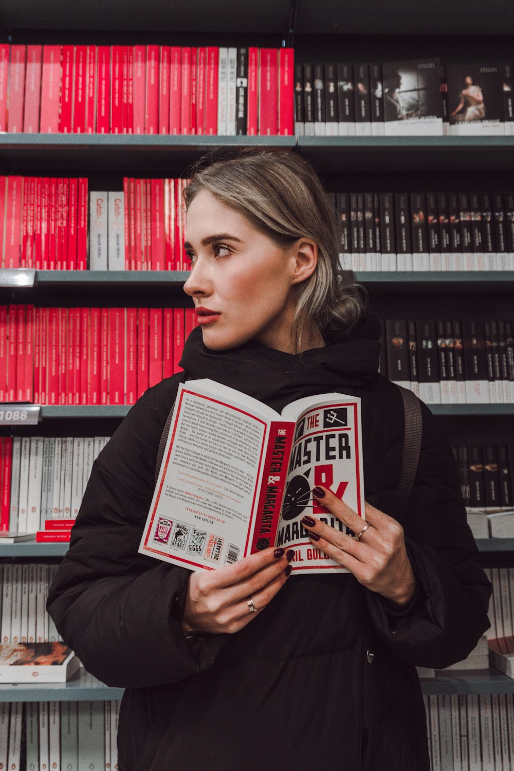 woman standing while holding book