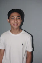 A smiling teenager proudly showing their new aligned teeth after orthodontic treatment.