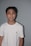 A happy young adult smiling confidently after completing orthodontic treatment.