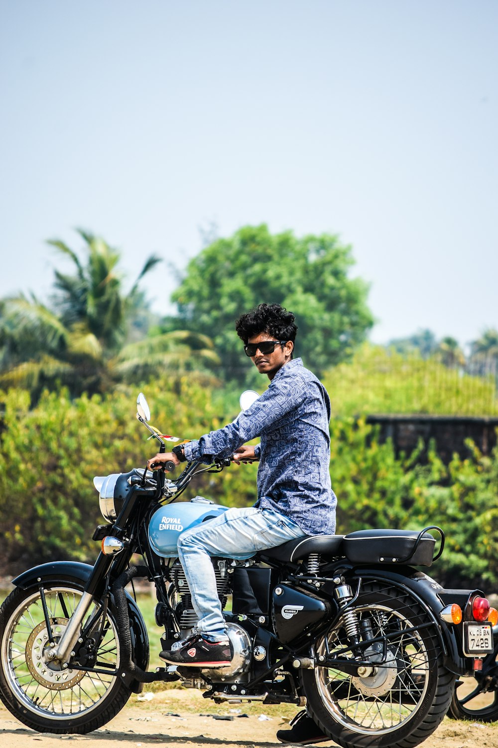 man riding on blue standard motorcycle