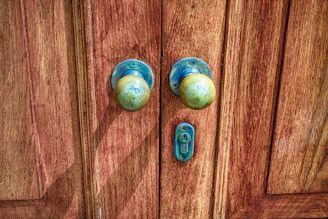 Vintage brass knobs adding a charming touch to rustic kitchen cabinets.