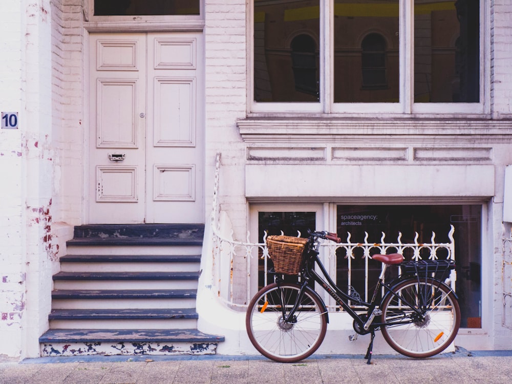 brown bike parked beside house