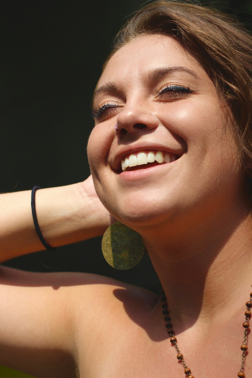 woman wearing gold-colored earring