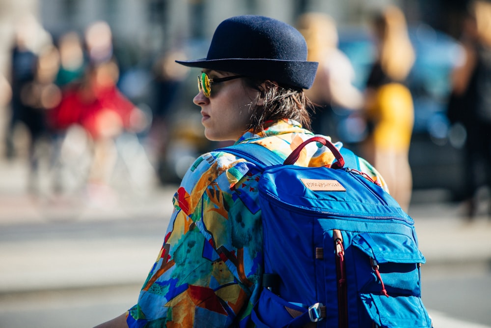 close-up photography of woman wearing blue backpack
