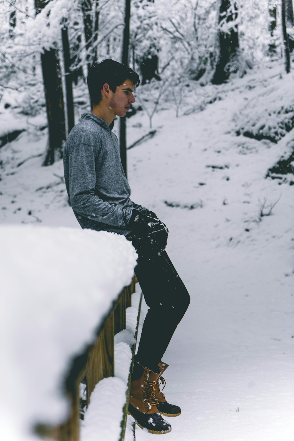 man sitting on wooden surface