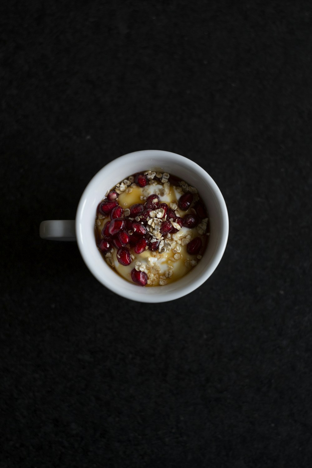 pomegranate seeds and cereals in mug