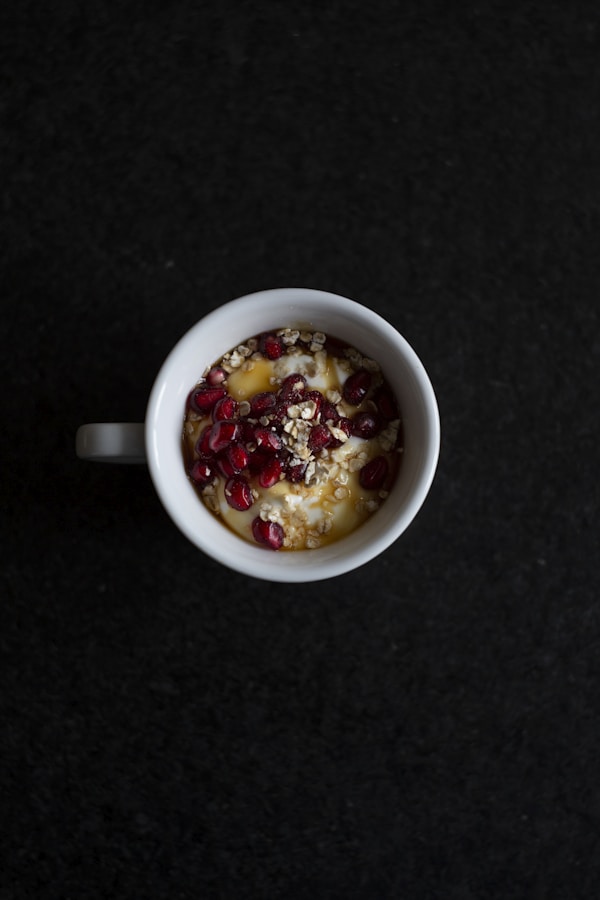 Pomegranate seeds and cereals in mug