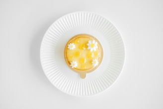 Colorful seasonal fruit tart with a shiny glaze, placed on a simple white ceramic plate
