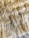A close-up view of a textured, woven fiber material with tightly interwoven strands. The fibers appear soft yet robust, with a natural, earthy hue.