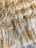 A close-up view of a textured, woven fiber material with tightly interwoven strands. The fibers appear soft yet robust, with a natural, earthy hue.