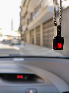 Close-up of a custom diamond-encrusted pendant catching the light on a city street background