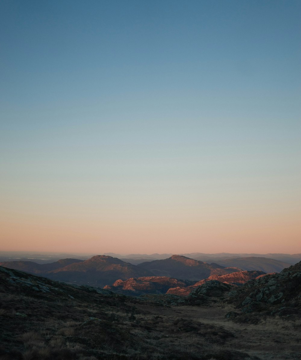 aerial photography of mountains under clear blue sky