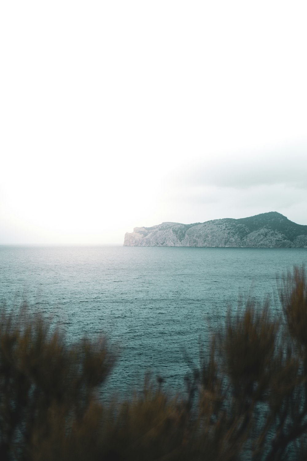 clear blue sea beside rock formation