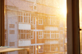 Sunlight filtering through city buildings highlighting the texture of Lumina Apparel’s fabrics.
