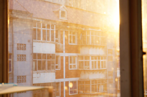 Sunlight filtering through city buildings highlighting the texture of Lumina Apparel’s fabrics.