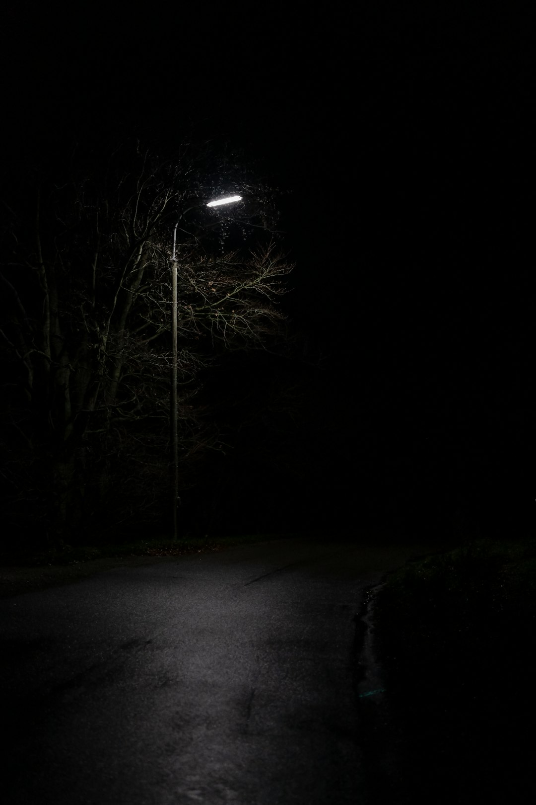 view of empty road under light post