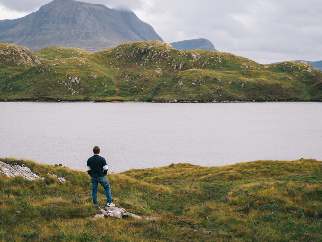 man standing near lake in forest