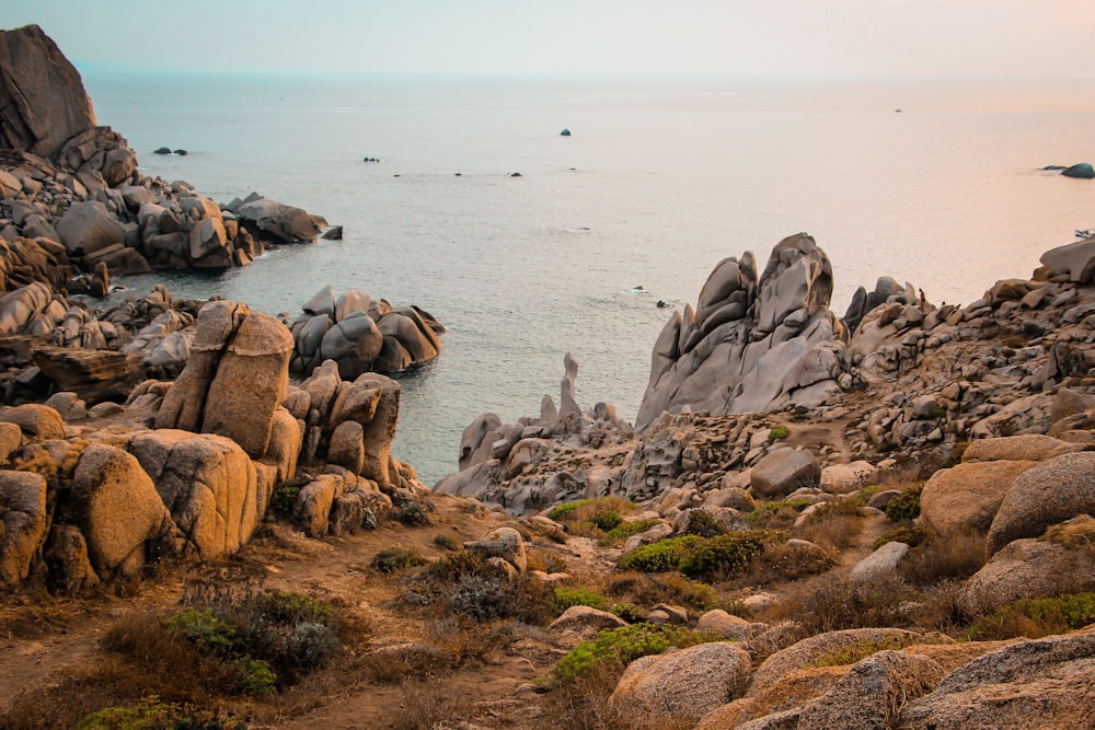 rocky island beside beach