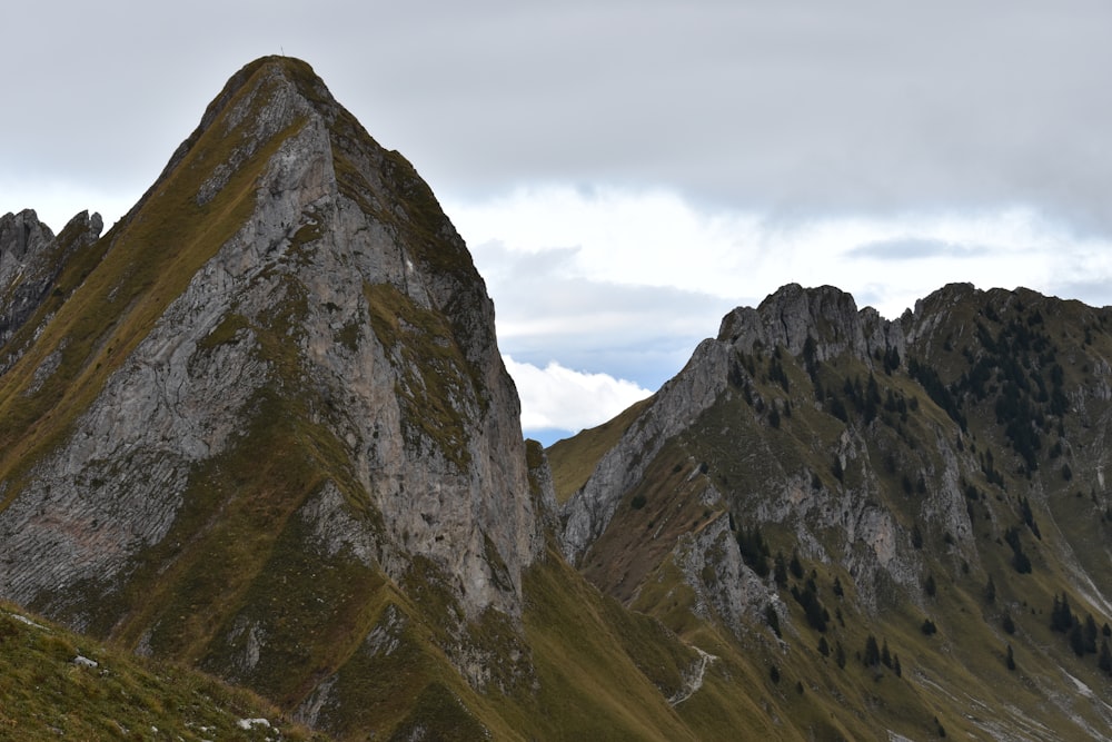 brown mountain under gray cloudy sky